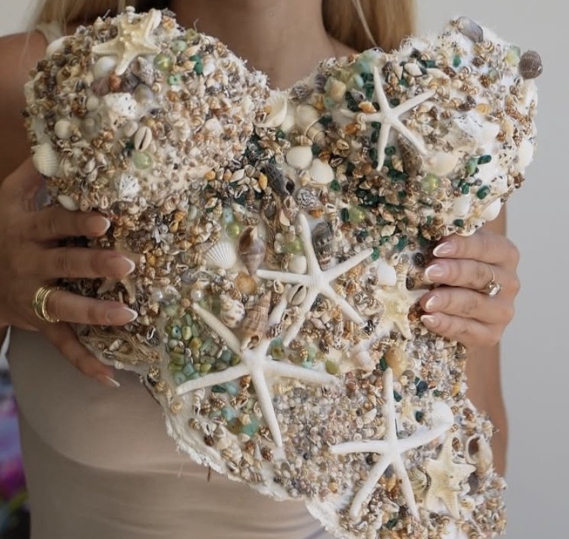 Sculptural torso encrusted with shells, starfish and glass beads.